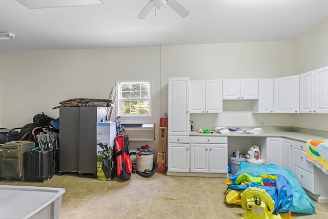 kitchen featuring white cabinetry and ceiling fan