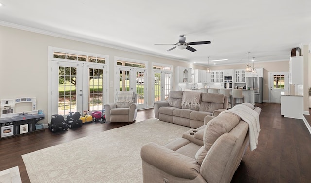 living room with french doors, dark hardwood / wood-style floors, and ornamental molding