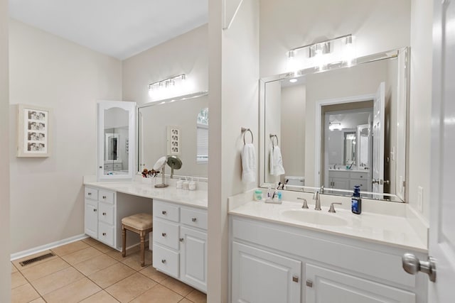 bathroom with tile patterned flooring and vanity