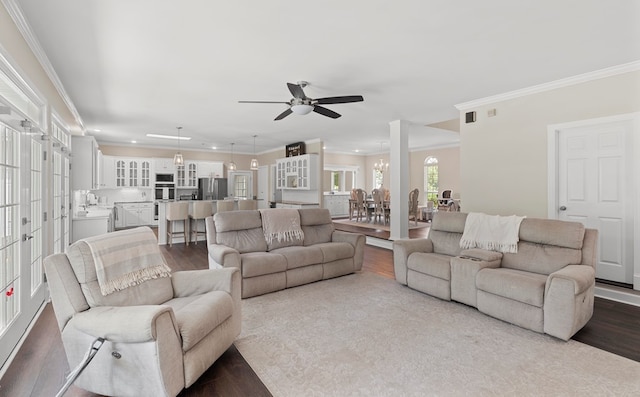 living room featuring hardwood / wood-style floors, ceiling fan, ornamental molding, and sink