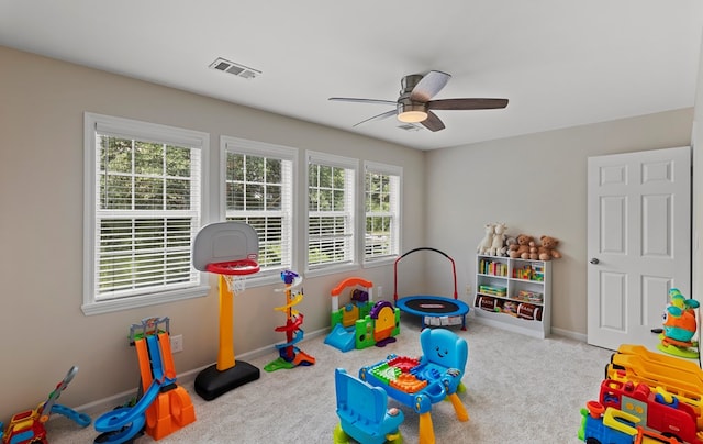 playroom featuring plenty of natural light, ceiling fan, and light carpet