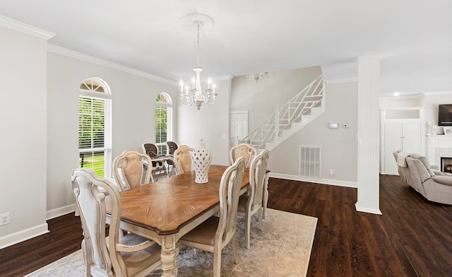 dining space featuring a notable chandelier, dark hardwood / wood-style flooring, and ornamental molding