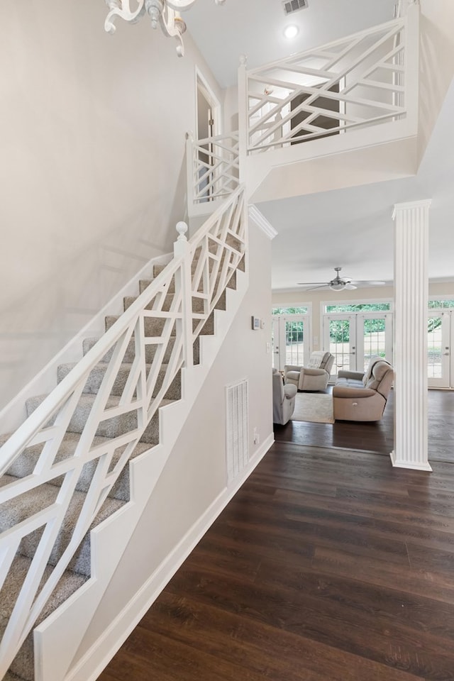 stairway featuring hardwood / wood-style floors, ceiling fan, and french doors