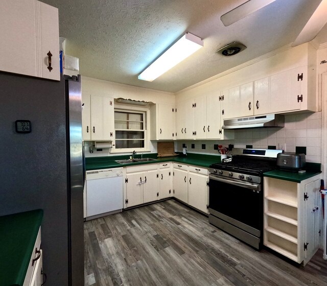 kitchen featuring stainless steel appliances, white cabinetry, sink, and dark hardwood / wood-style floors