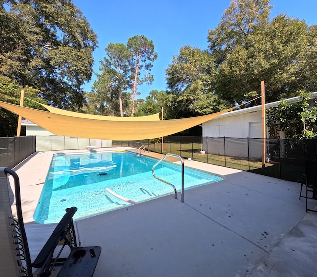 view of swimming pool with a patio area