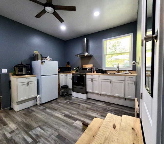 kitchen with white cabinetry, sink, wall chimney exhaust hood, and appliances with stainless steel finishes