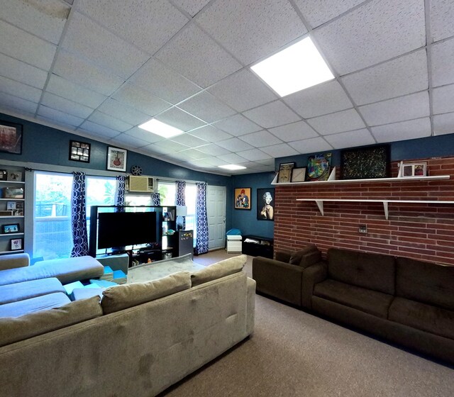 living room featuring carpet and a paneled ceiling