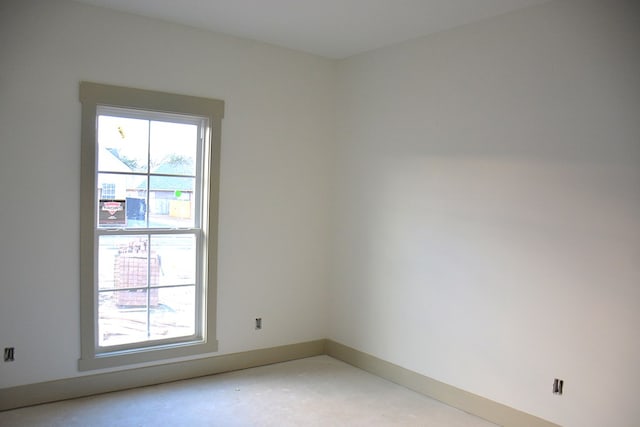 unfurnished room with concrete floors