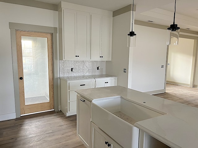 laundry area with light wood finished floors