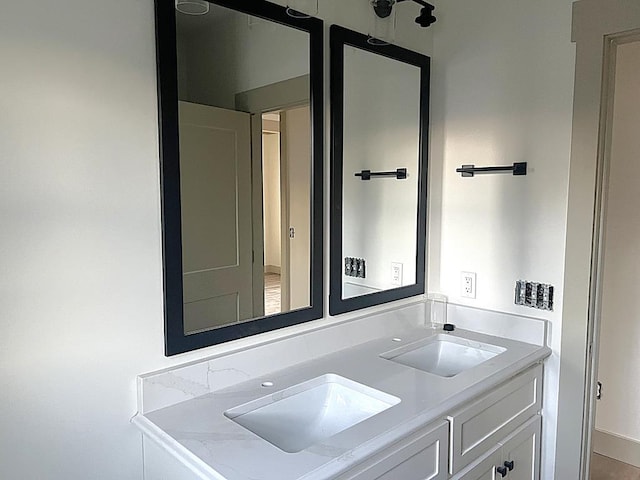 bathroom with a sink and double vanity