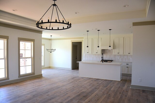 kitchen with white cabinets and premium range hood