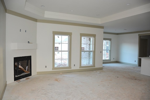 unfurnished living room featuring ornamental molding and a tray ceiling