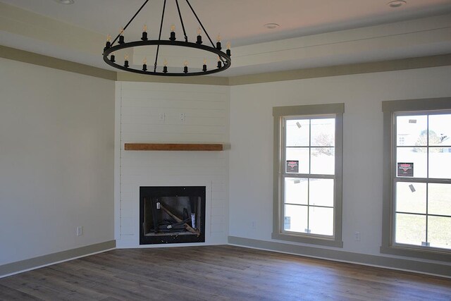 kitchen with white cabinetry, a kitchen island, hanging light fixtures, and a notable chandelier