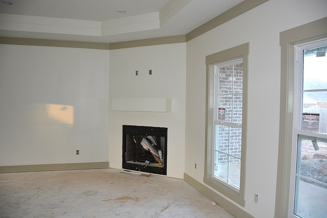 unfurnished living room with a tray ceiling