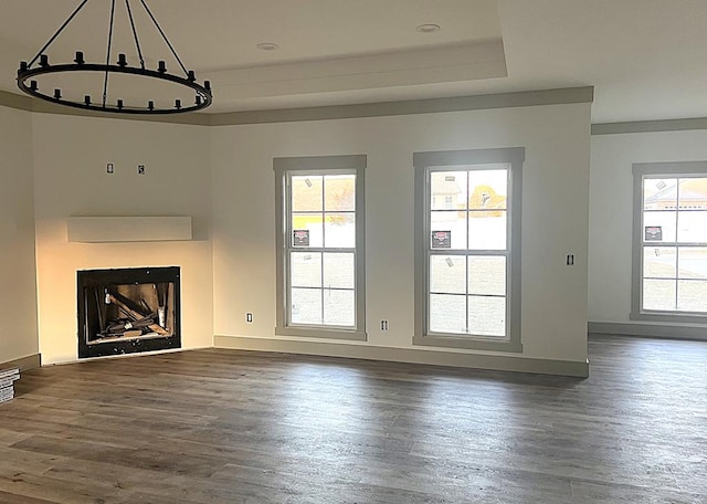 unfurnished living room featuring a fireplace, baseboards, and dark wood-style flooring