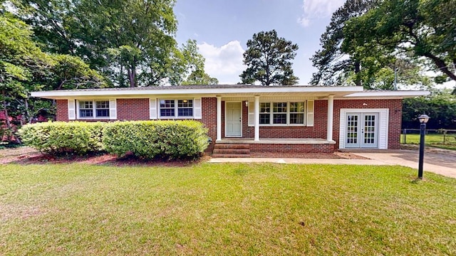 1007 Deborah St, Dothan, AL 36301 - ranch-style house featuring french doors, a front lawn, covered porch, and brick siding