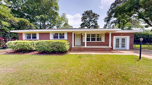 1007 Deborah St, Dothan, AL 36301 - single story home featuring french doors, a front yard, a porch, and brick siding