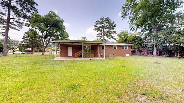 1007 Deborah St, Dothan, AL 36301 - rear view of house with a fenced backyard, stairway, a patio area, and brick siding