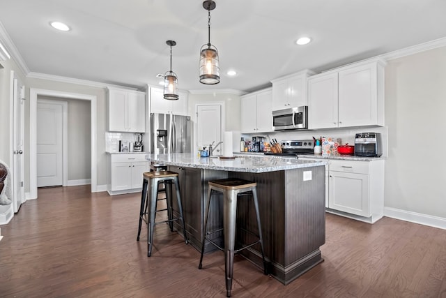 2027 S County Road 9, Newton, AL 36352 - kitchen featuring appliances with stainless steel finishes, a breakfast bar area, ornamental molding, recessed lighting, and an island with sink