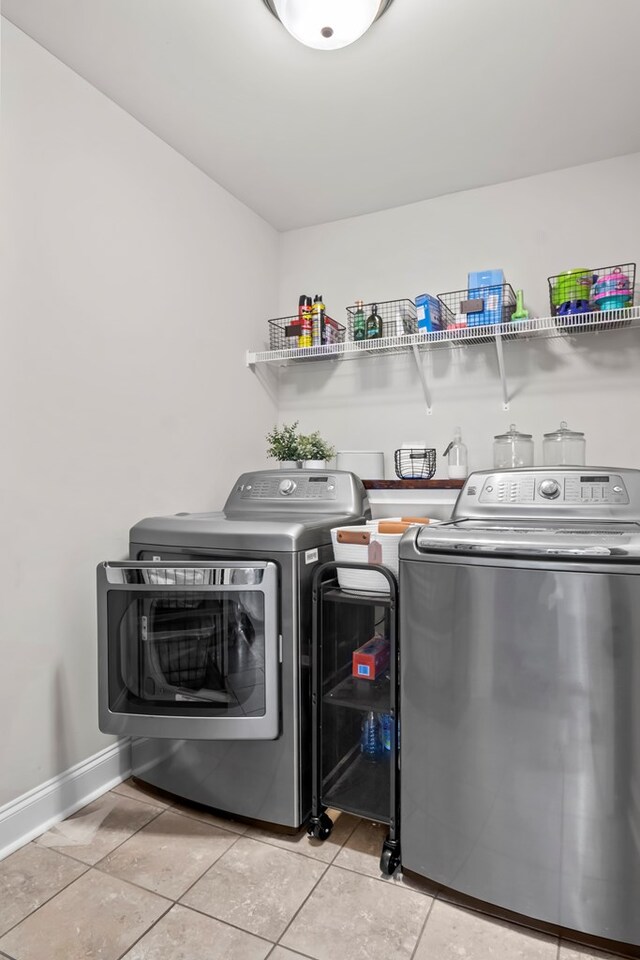 2027 S County Road 9, Newton, AL 36352 - laundry room with washer and clothes dryer and light tile patterned floors