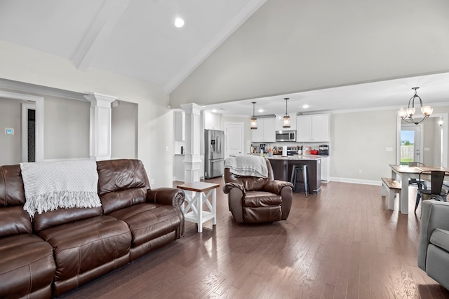 2027 S County Road 9, Newton, AL 36352 - living area with dark wood finished floors, high vaulted ceiling, recessed lighting, a chandelier, and decorative columns