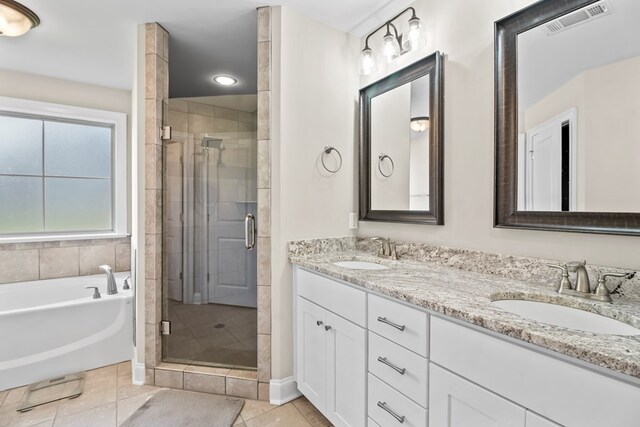 2027 S County Road 9, Newton, AL 36352 - full bath featuring a shower stall, double vanity, a garden tub, and tile patterned floors