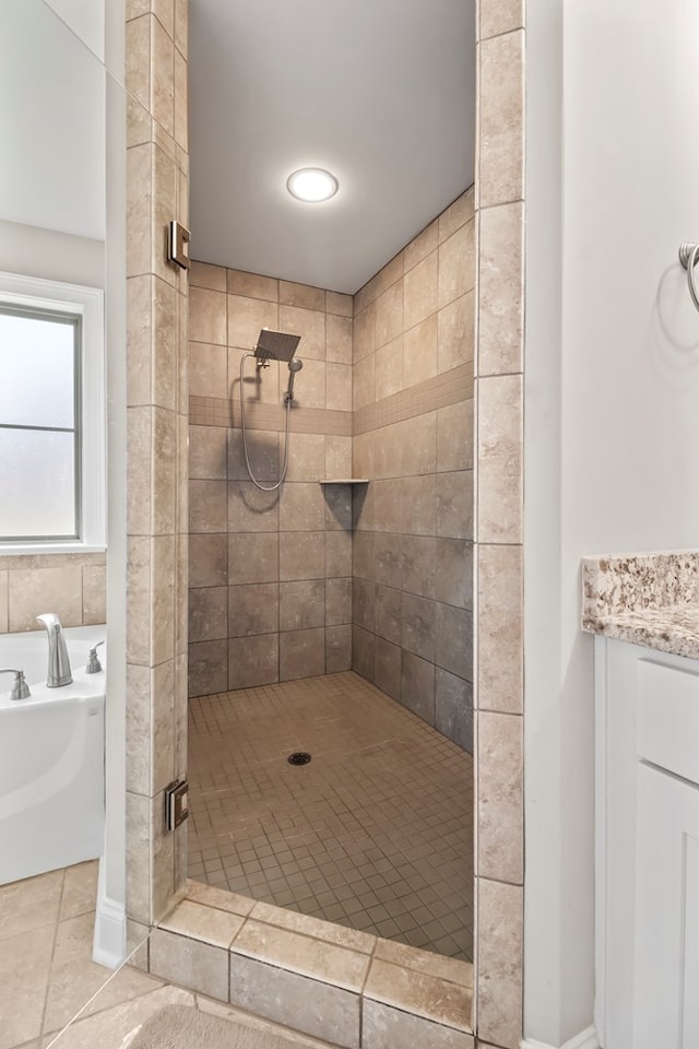 2027 S County Road 9, Newton, AL 36352 - bathroom with a stall shower, a garden tub, tile patterned floors, and vanity