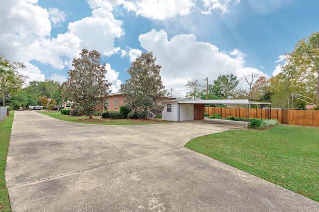 single story home featuring a front lawn and a carport