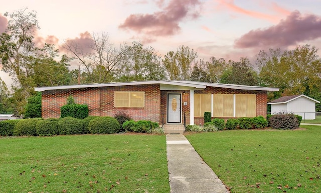 view of front of house with a yard