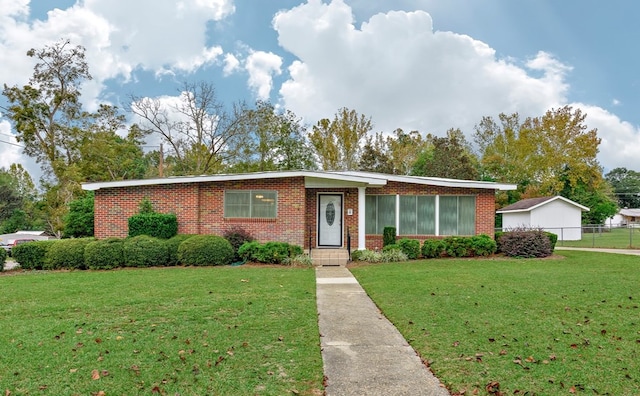 ranch-style home with a front lawn