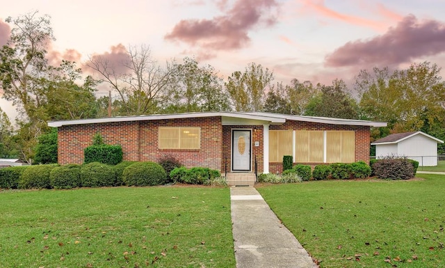4 W Morris St, Samson, AL 36477 - view of front of house featuring a yard and brick siding