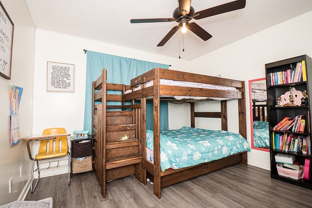bedroom featuring wood finished floors and baseboards