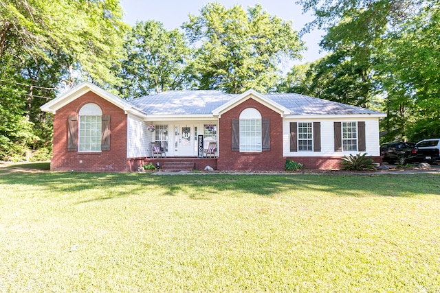 ranch-style home featuring brick siding, a porch, and a front yard