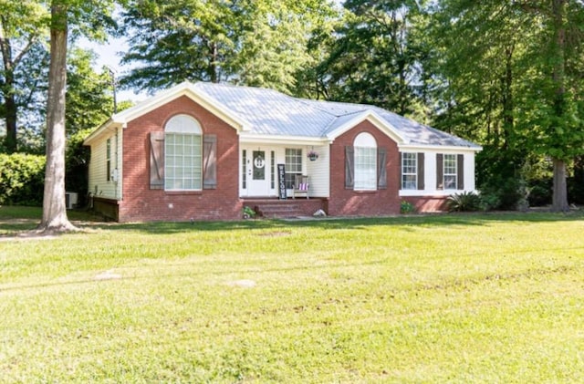view of front of property with a front lawn, covered porch, and brick siding
