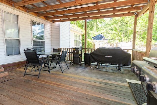 wooden terrace with grilling area and outdoor dining space