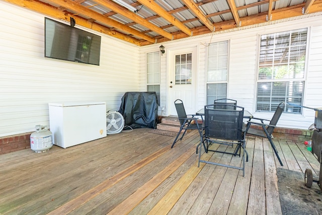 wooden deck with area for grilling and outdoor dining area