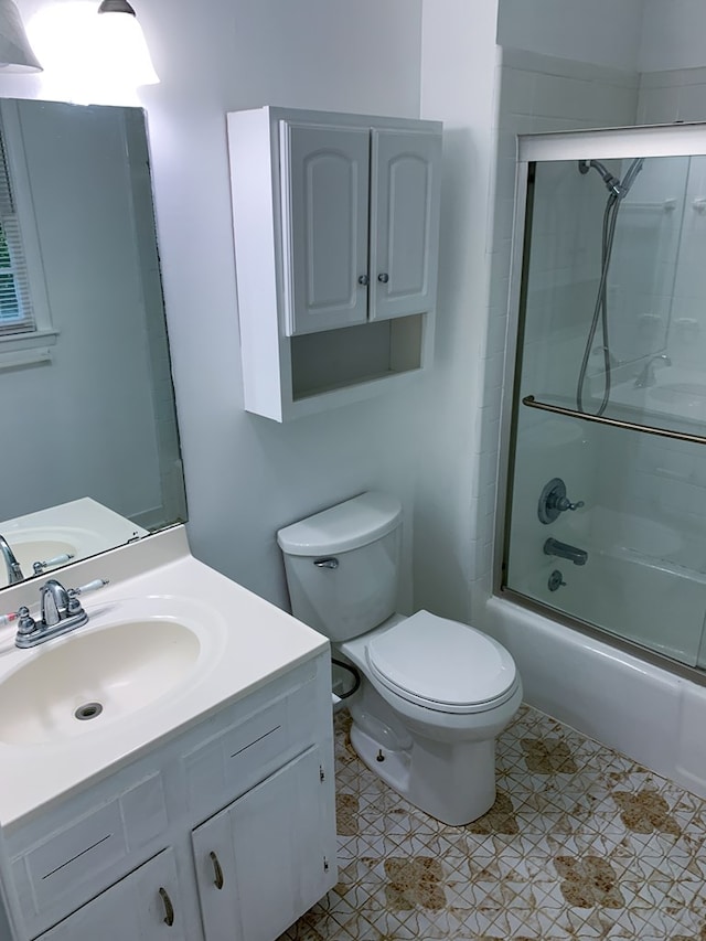 full bathroom with tile patterned flooring, vanity, toilet, and enclosed tub / shower combo