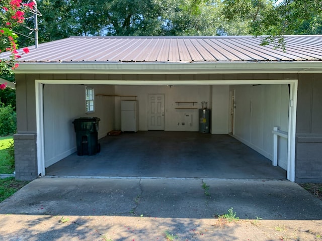 garage with white fridge and electric water heater