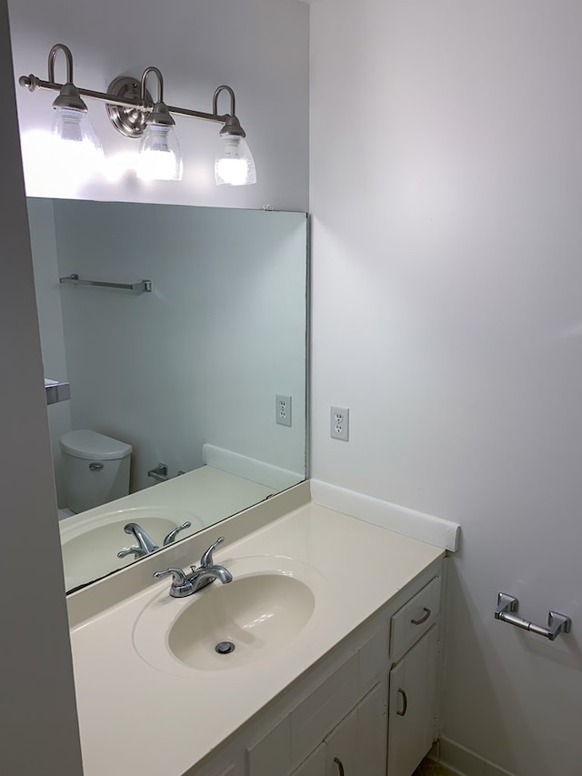 bathroom with vanity and toilet