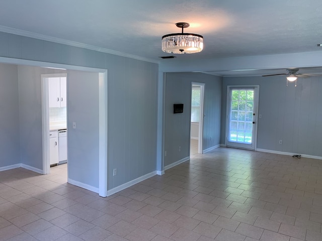 empty room with ceiling fan, light tile patterned floors, and crown molding