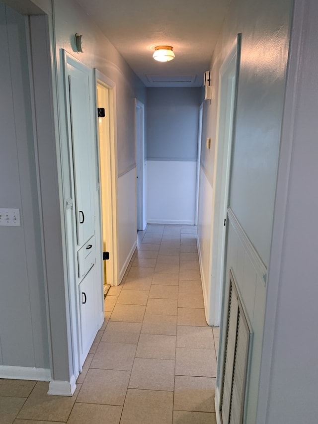 hall with light tile patterned floors