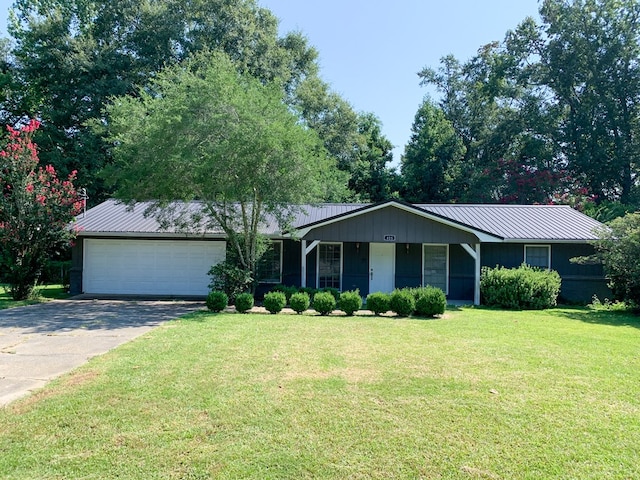 ranch-style home with a front lawn and a garage