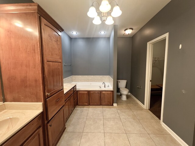 305 Millenia St, Enterprise, AL 36330 - bathroom with tile patterned floors, a bath, toilet, a chandelier, and a walk in closet