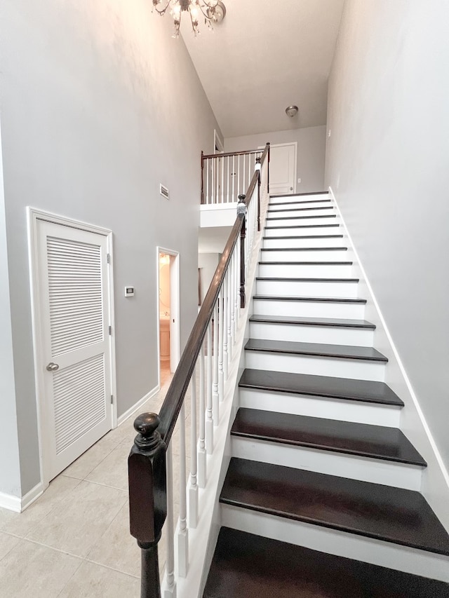 305 Millenia St, Enterprise, AL 36330 - staircase featuring tile patterned floors, a high ceiling, and baseboards