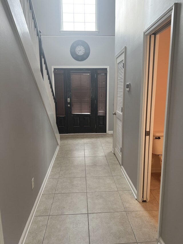 305 Millenia St, Enterprise, AL 36330 - entryway with tile patterned flooring, stairway, a high ceiling, and baseboards
