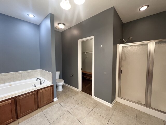 305 Millenia St, Enterprise, AL 36330 - bathroom featuring toilet, a stall shower, a garden tub, a spacious closet, and tile patterned floors
