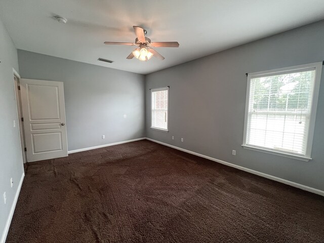305 Millenia St, Enterprise, AL 36330 - empty room with ceiling fan, dark colored carpet, and baseboards