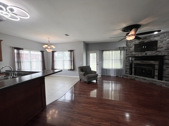 305 Millenia St, Enterprise, AL 36330 - living room featuring a chandelier, wood finished floors, a fireplace, and a ceiling fan