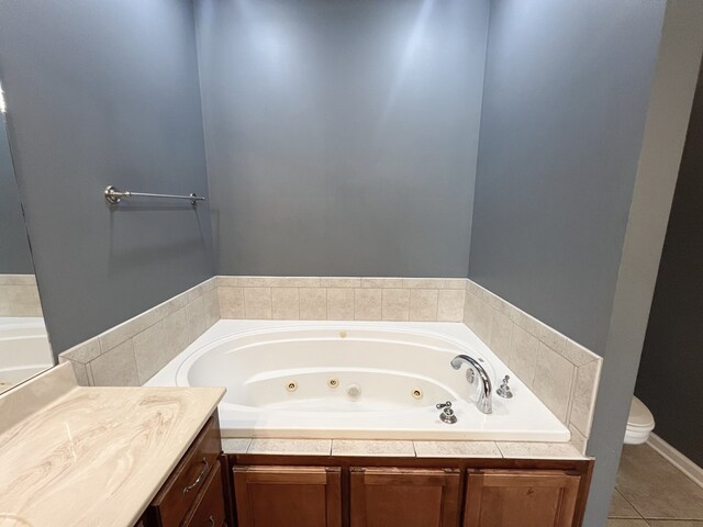 305 Millenia St, Enterprise, AL 36330 - bathroom featuring a tub with jets, toilet, vanity, and tile patterned floors