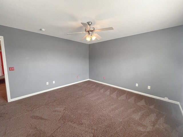 305 Millenia St, Enterprise, AL 36330 - spare room featuring a ceiling fan, dark carpet, and baseboards